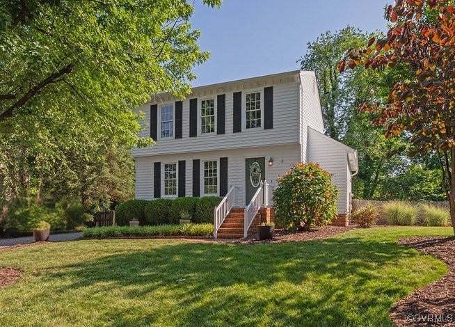 Colonial-style house with a front lawn