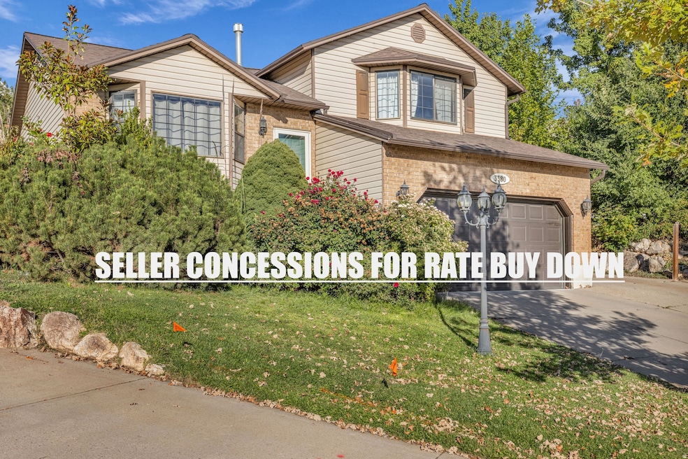 Traditional home with brick siding, driveway, a garage, and a front yard