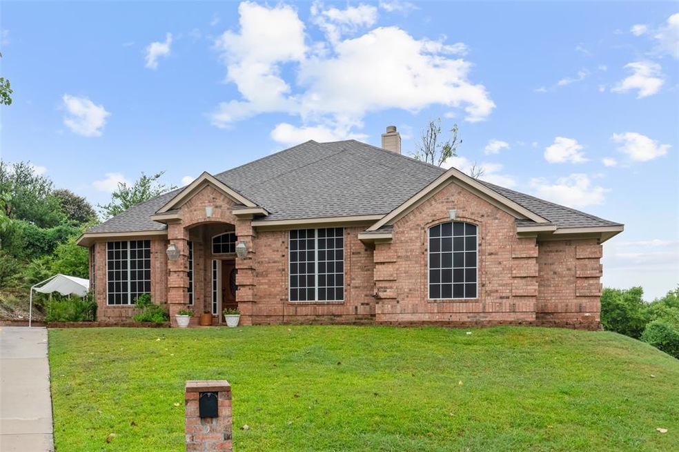 Perched on top of a lovely lot with extended drive