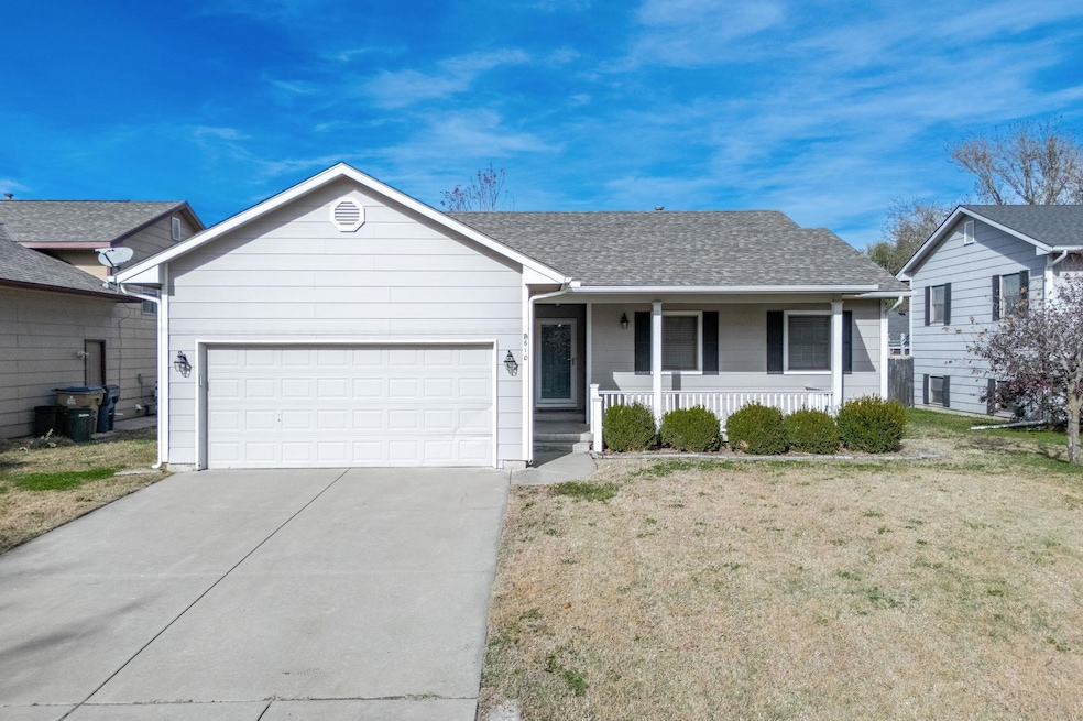 Ranch-style home with a porch, a shingled roof, a front lawn, concrete driveway, and an attached garage