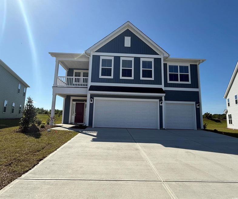View of front of home with an attached garage, dri