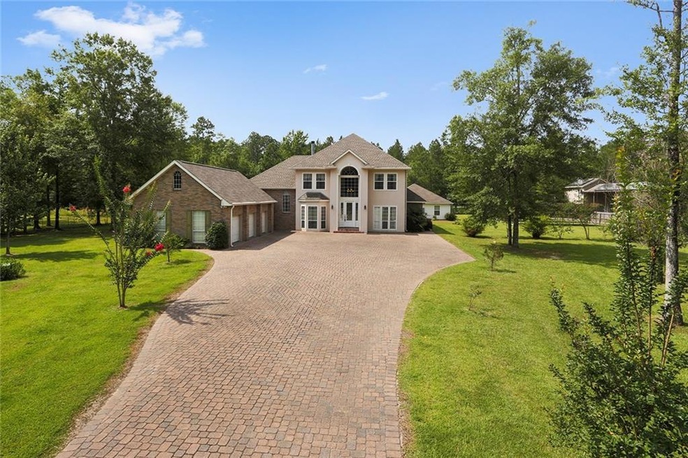 Welcoming gated entrance with tremendous paver dri