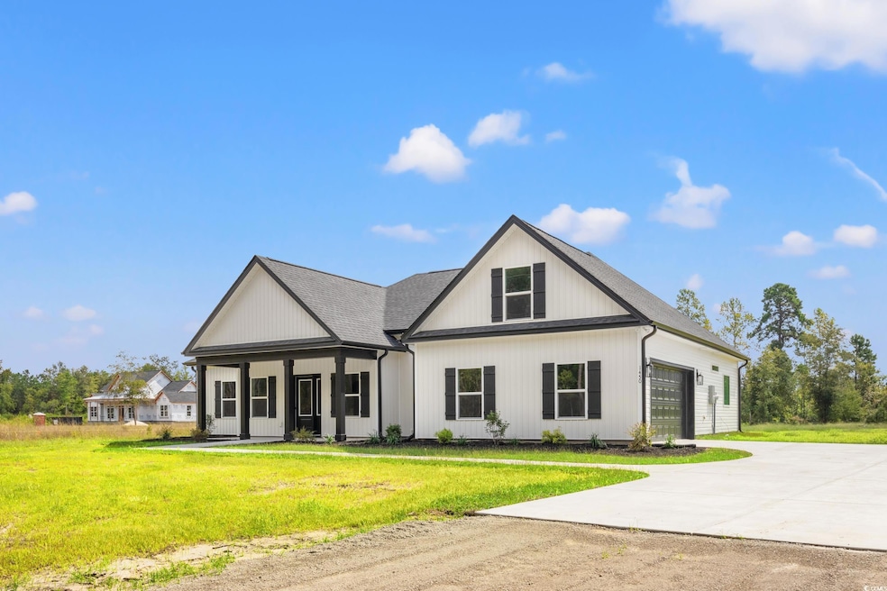 Modern farmhouse featuring a front yard and a gara