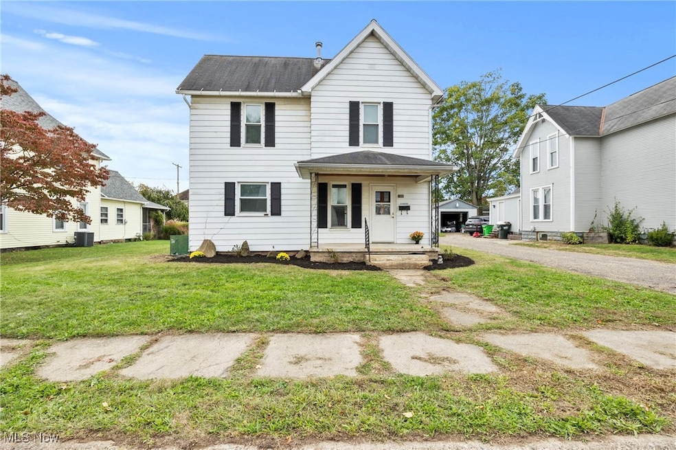 Traditional-style house with a front lawn and a porch