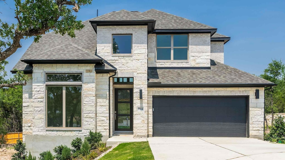 View of front of home featuring stone siding, a s