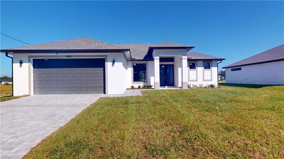 Prairie-style home with stucco siding, driveway, r