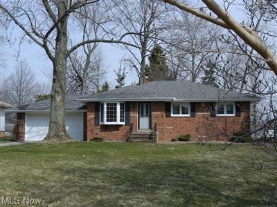 HOME HAS A BRICK FRONT WITH BAY WINDOW AND SITS FA