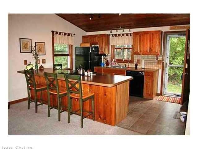 Kitchen. The kitchen features a breakfast bar with