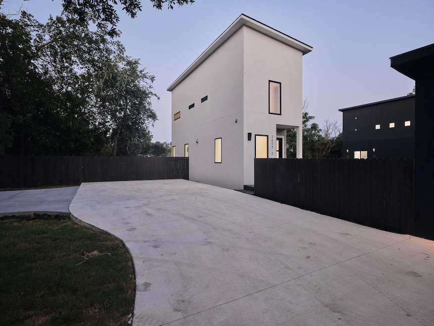 Property exterior at dusk featuring stucco siding
