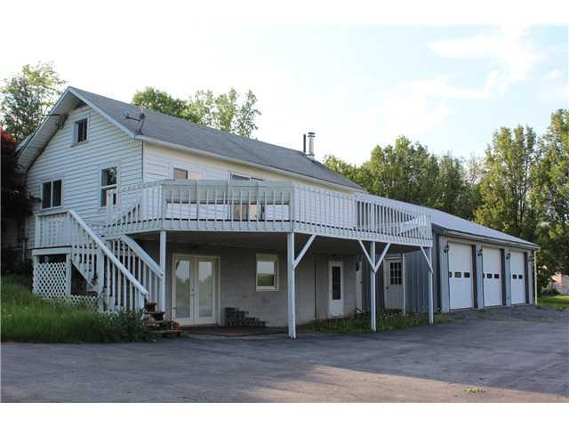Exterior Front. Spacious vinyl sided home. 3 bay e