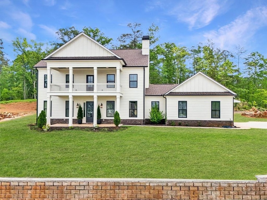 Neoclassical home with a porch, a balcony, board a