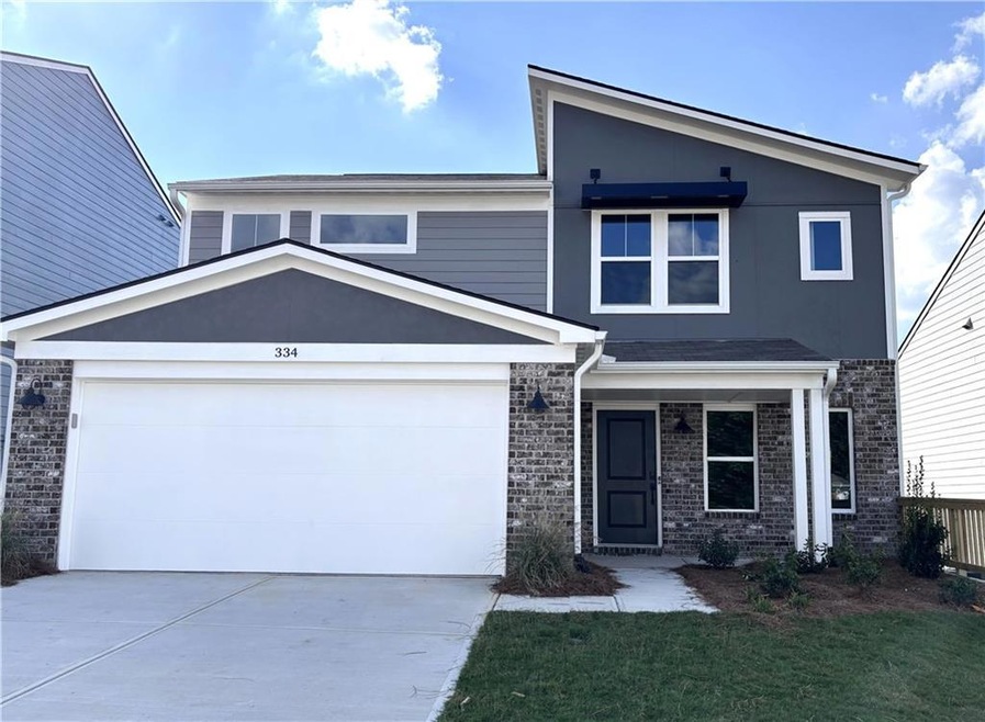 View of front of house featuring a garage and a front lawn