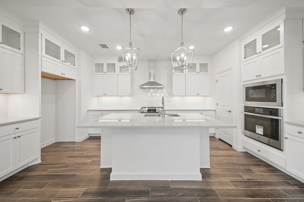 Lovely kitchen with white stacked cabinets and qua