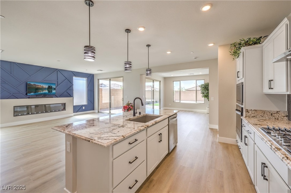 Kitchen featuring a sink, open floor plan, light w