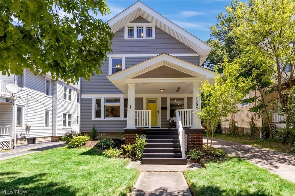 View of front of property with covered porch and a front yard