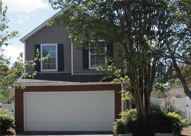 Beautiful partial brick exterior with two car gara