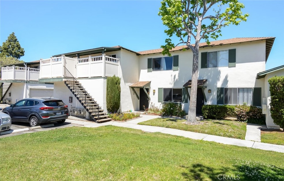 Front exterior of Unit C with attached garage and guest parking.