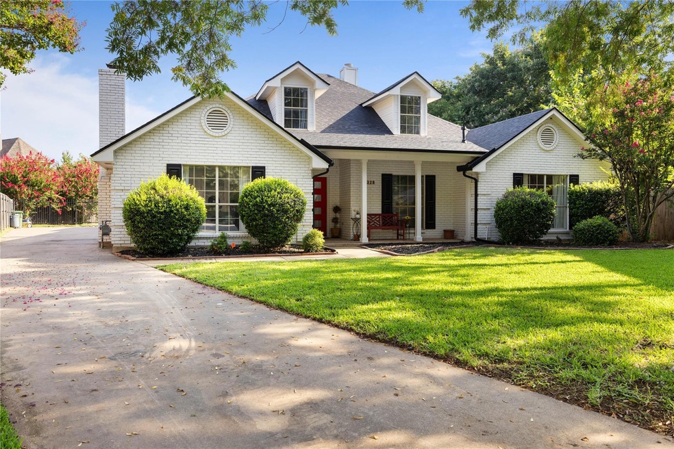 Cape cod-style house with a front lawn and covered
