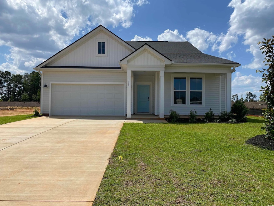 Modern farmhouse style home with driveway, a front yard, a garage, and board and batten siding