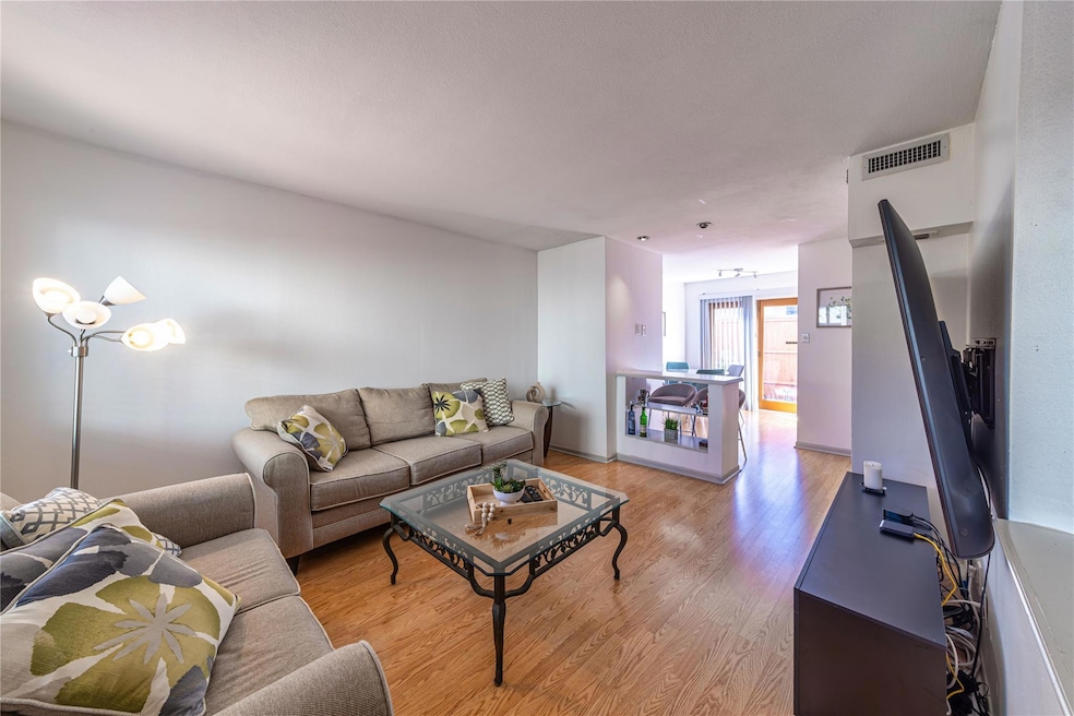 Living area featuring visible vents and light wood