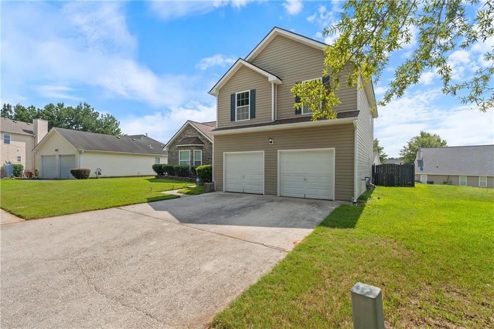 Traditional-style house with concrete driveway and a garage