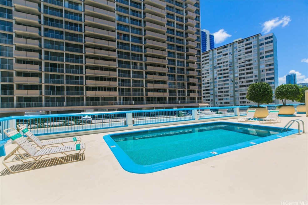 Sunny pool deck with covered seating for comfort