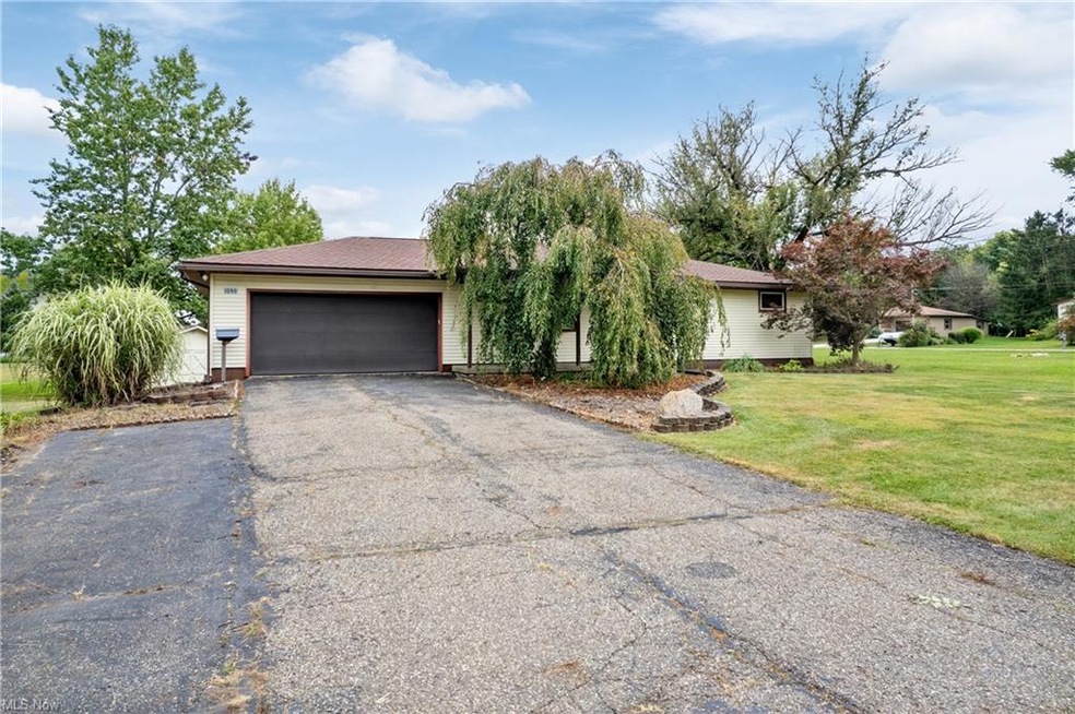 Ranch-style house with garage and a front lawn