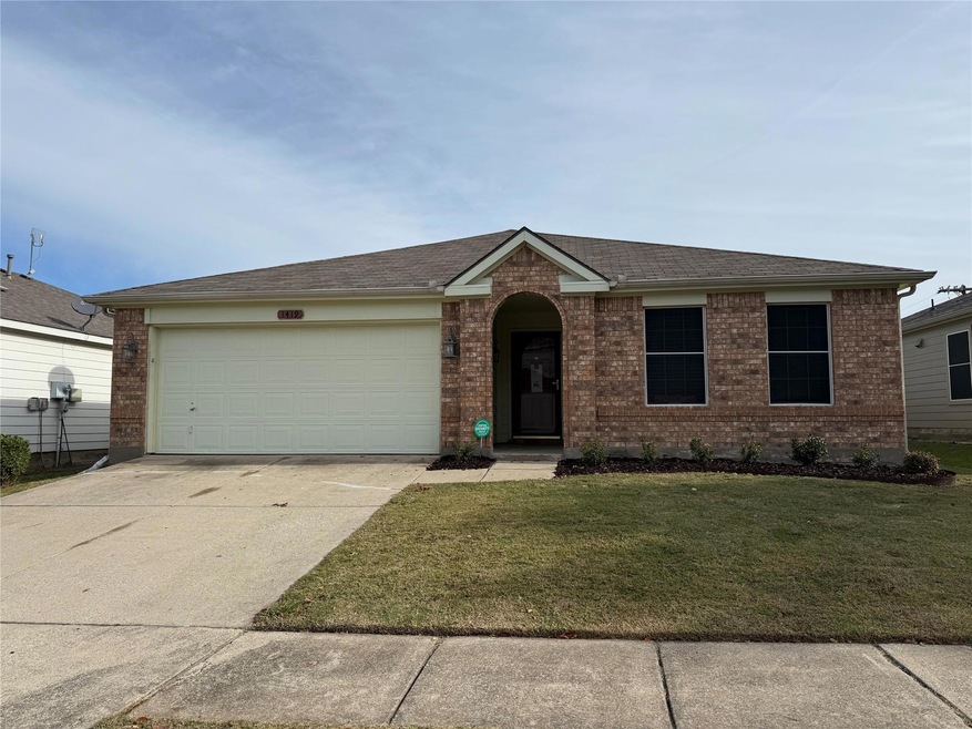 Ranch-style home featuring a garage and a front lawn