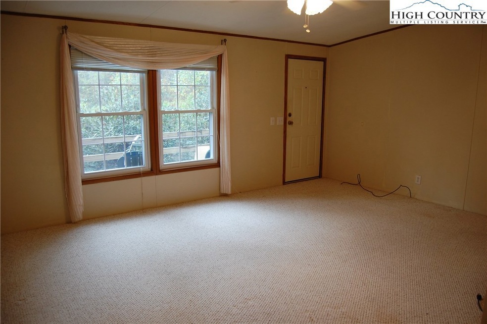 Living room opens to deck with seasonal Grandfather Mountain View