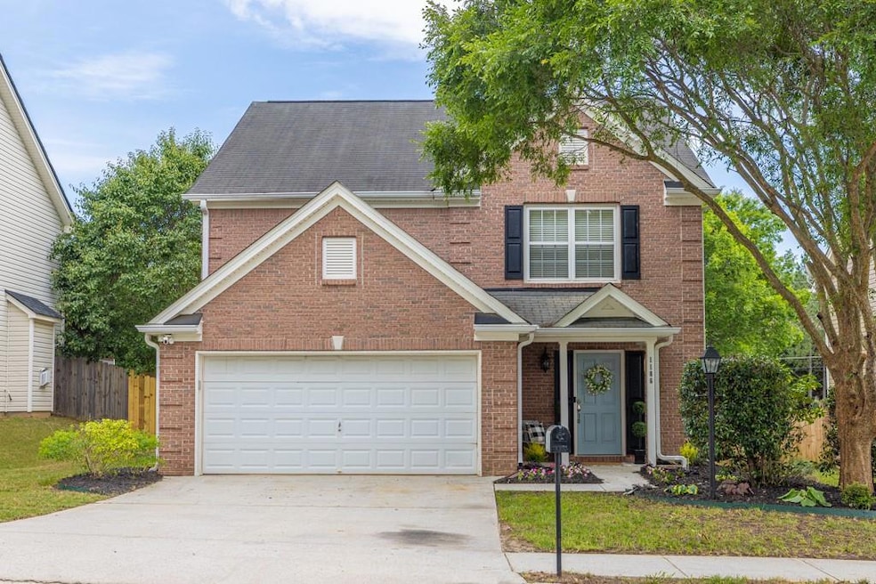 Great curb appeal! This charming brick home offers a large shade tree and well-maintained landscaping