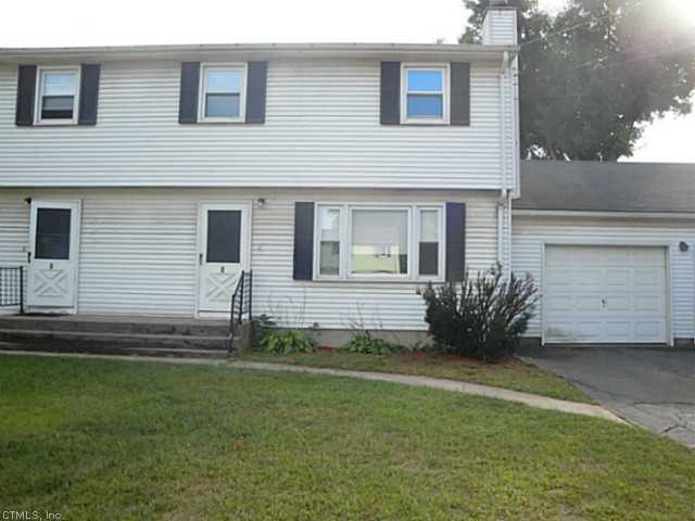 Exterior Front. Half a duplex with one car garage 