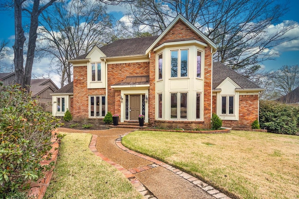 View of front of home with brick siding, roof with