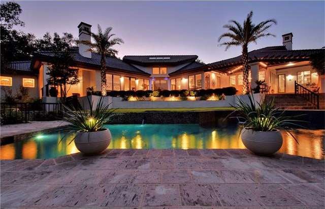 Pool terrace at dusk, showing the numerous windows