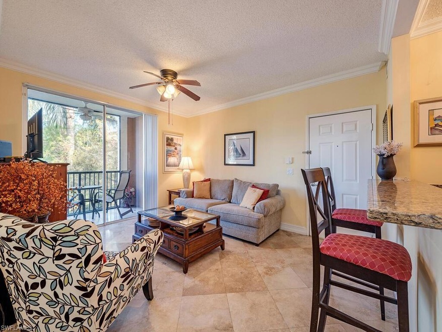 Living room with ceiling fan, light tile patterned