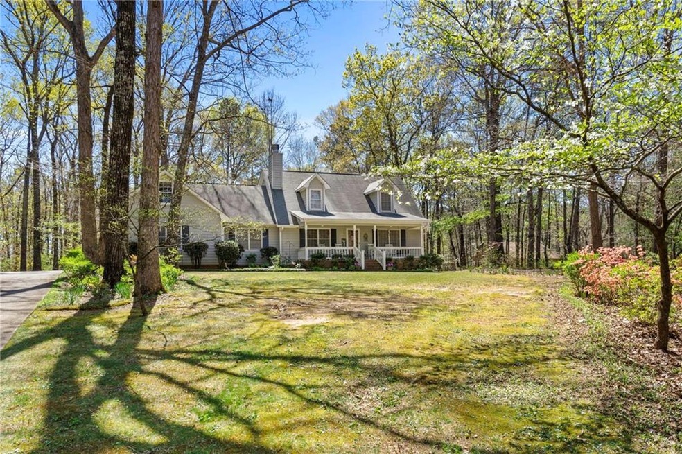 Cape cod home with a porch and a front lawn