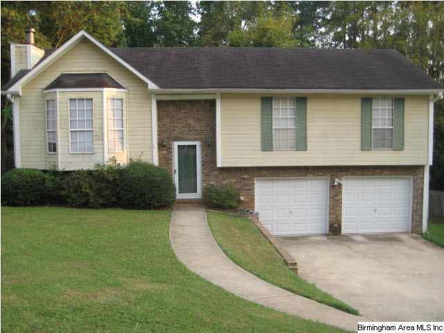 Front view of Home displaying large lawn and two c