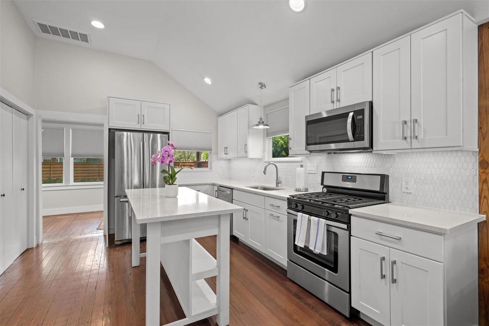Kitchen with decorative backsplash, visible vents
