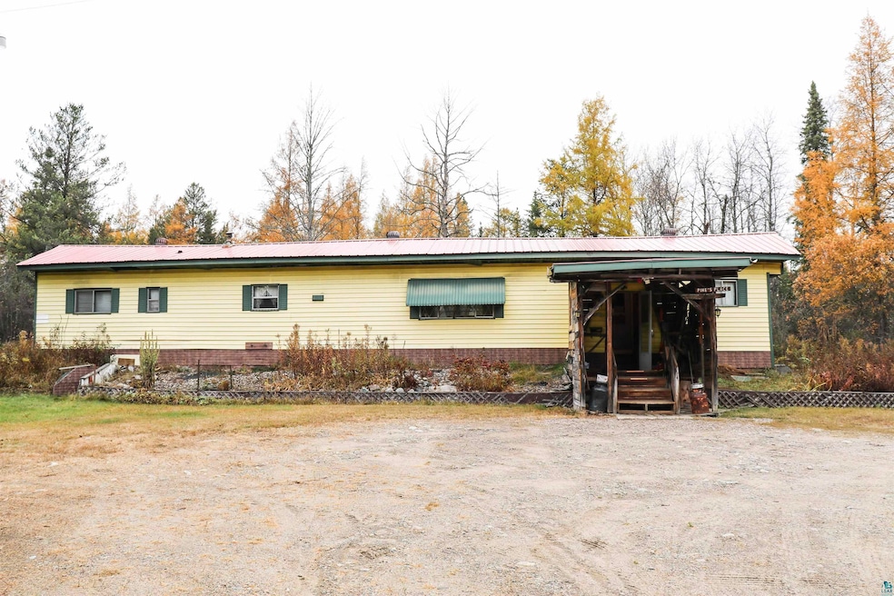 Rear view of property featuring fence and metal ro