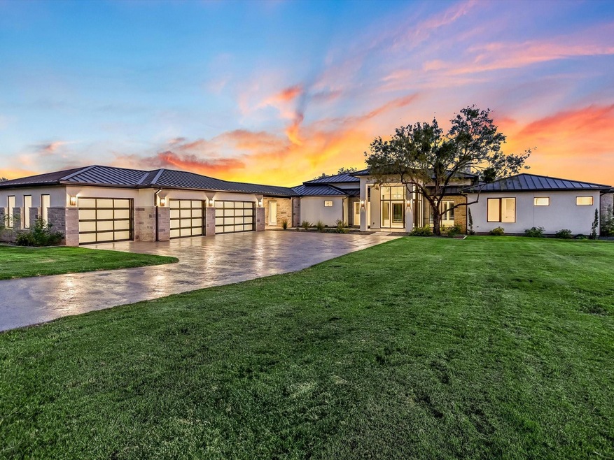View of front facade featuring driveway, a standin