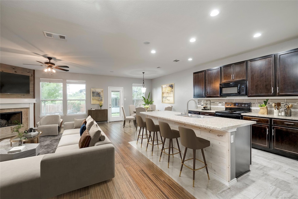 Kitchen with black appliances, open floor plan, a