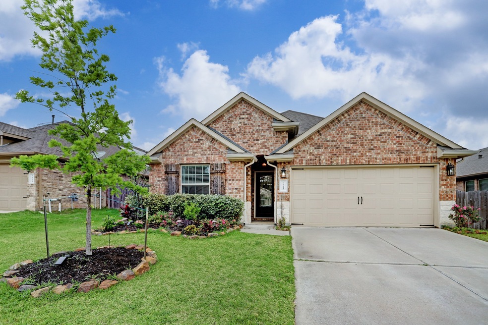 Welcome home to 7325 Masquerade Lane, boasting all brick exterior with stone accents and decorative shutters.