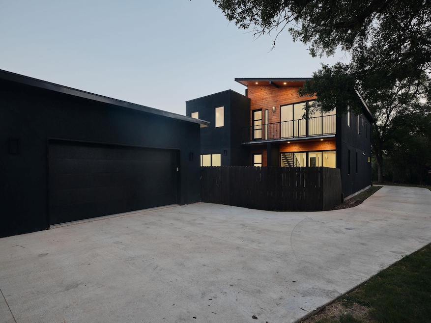 Contemporary home featuring driveway and stucco siding