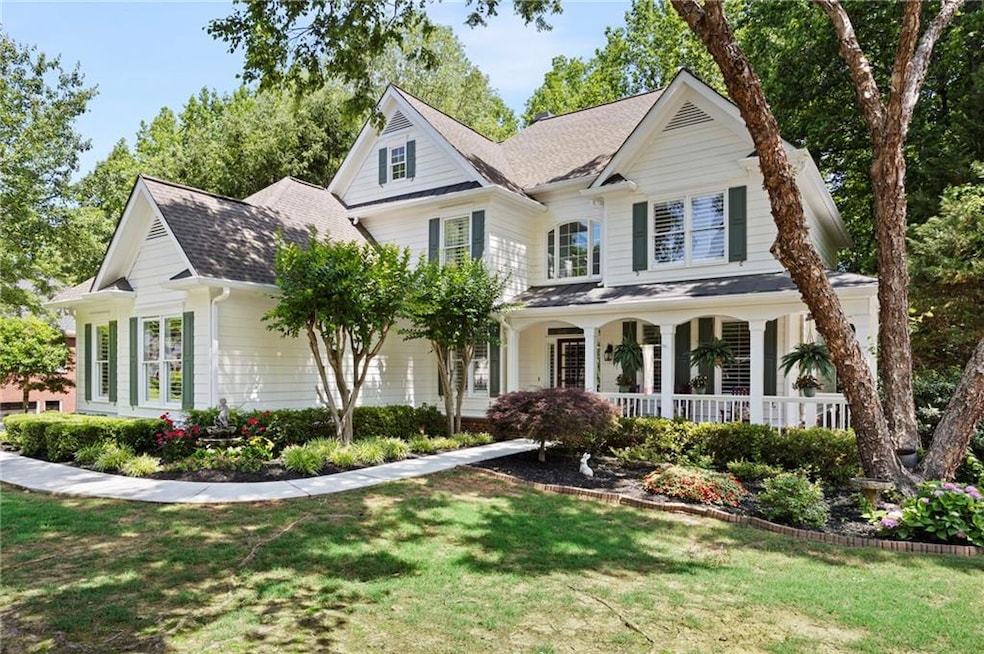 Traditional-style home with a porch, a front lawn, and a shingled roof