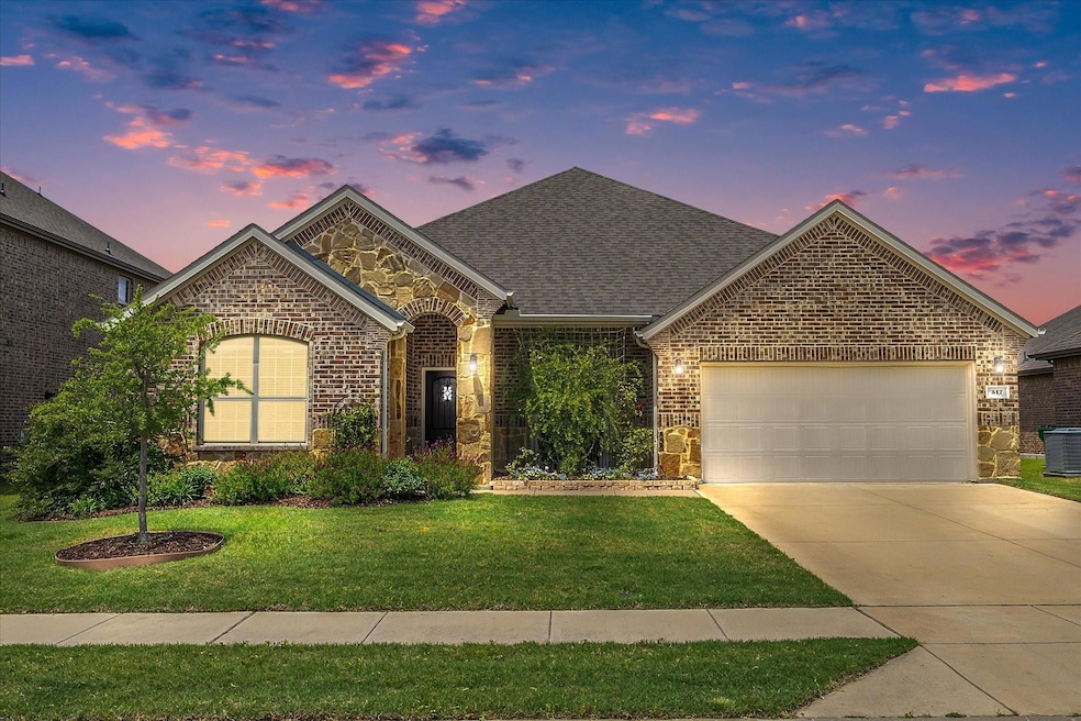 View of property featuring a garage, a yard, and central air condition unit