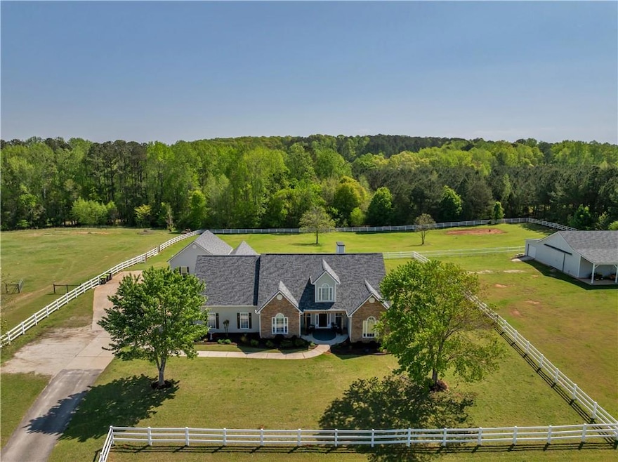 Birds eye view of property with a rural view and a view of trees