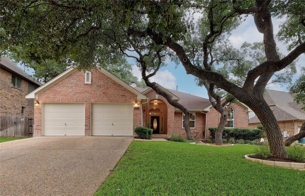 Single story home with a garage, brick siding, fe