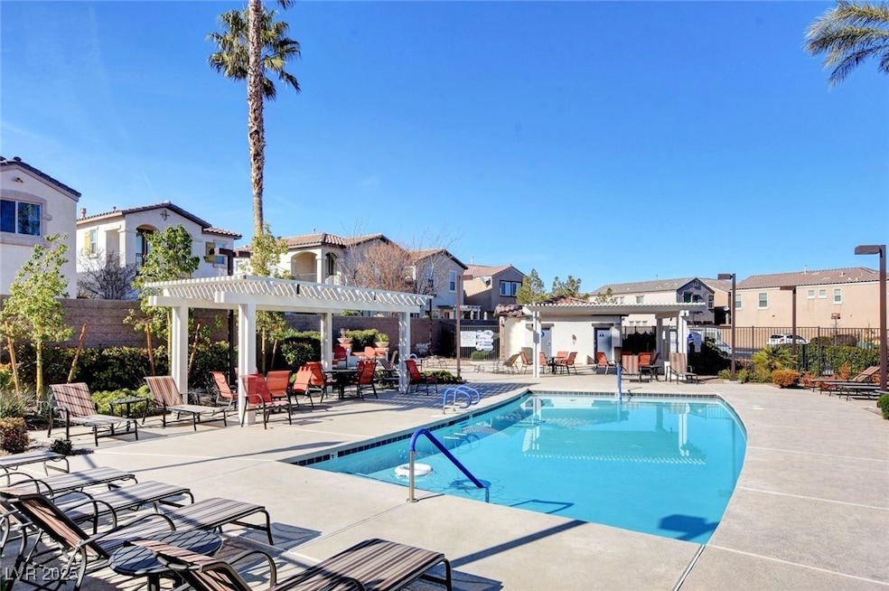 Community pool featuring a pergola, fence, a patio