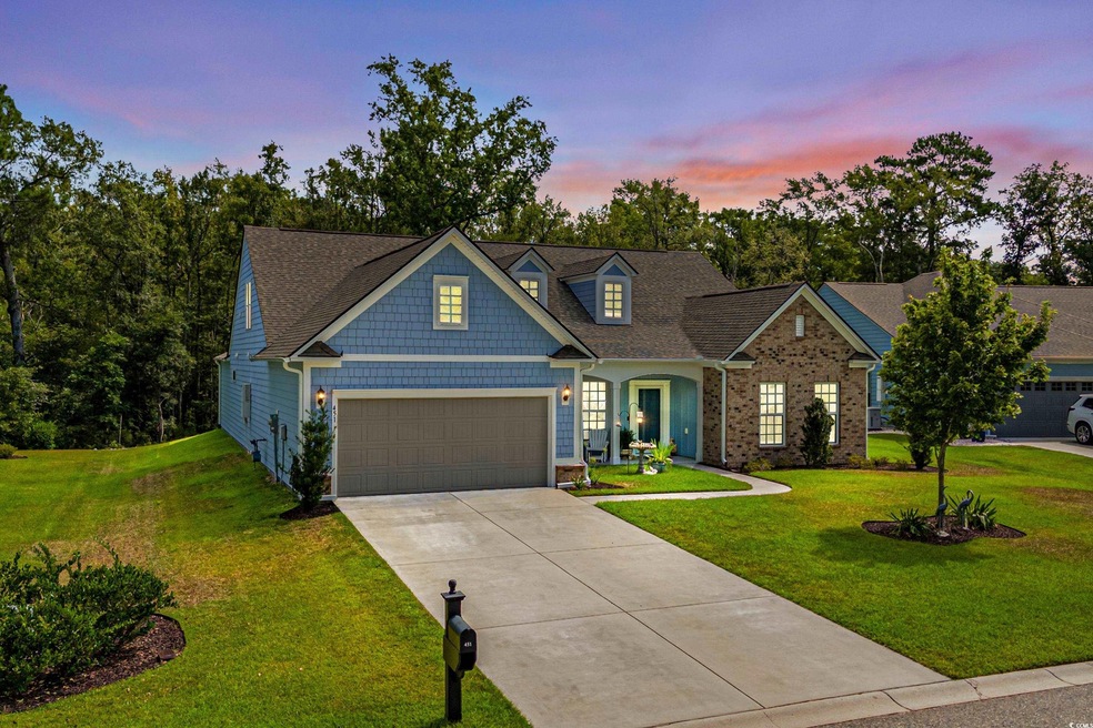 View of front of home featuring a garage and a law