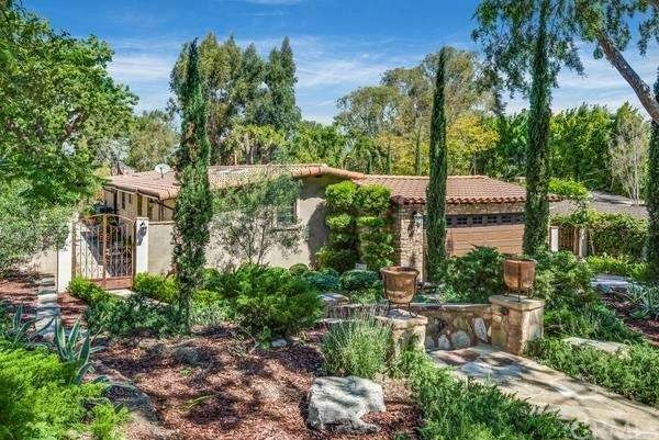 Beautifully landscaped yard and hard scape on driv
