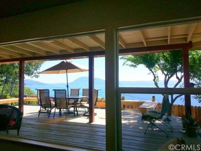 View of back deck and lake from living room